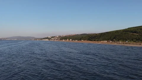 Aerial 4K Drone View of Coastal Village, Green Hills and Sea Shore Stock Footage 341528092