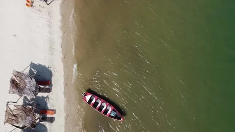Aerial 4K drone view of rustic fishing boat on tropical beach in Brazil Stock Footage 316336613