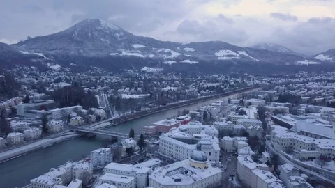 Aerial 4k fly over an old town on winter morning with a mountain view Stock Footage