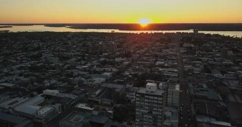 Aerial 4K - Flying over small city in the coastline on sunset Stock Footage 85648620