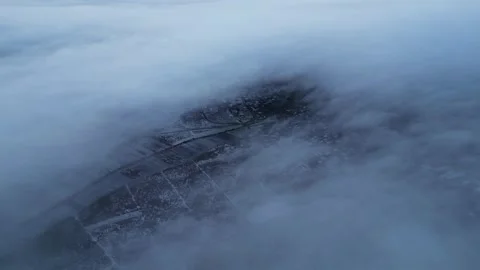 Aerial 4K forward flight into cloud break over winter fields Video stock 323162215