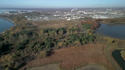 Aerial 4k high angle video of a pond with Factories in background Stock Footage 220243720