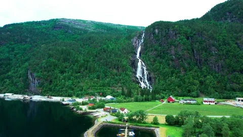 Aerial 4K-Norway-Flight drone Orbit pan up view-Mo waterfall village  Stock-Footage 200575053