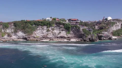 Aerial 4K view of a cliff, ocean waves, beach at Uluwatu, Bali, Indonesia Stock Footage 325085553