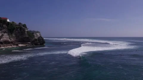 Aerial 4K view of a cliff, ocean waves, beach at Uluwatu, Bali, Indonesia Stock Footage 325085564