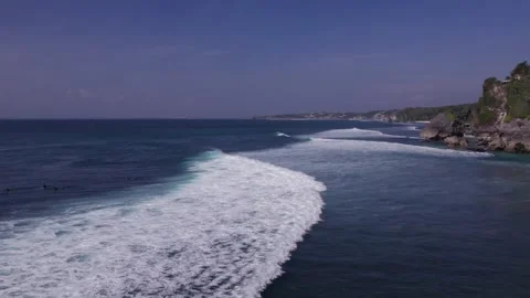 Aerial 4K view of a cliff, ocean waves, beach at Uluwatu, Bali, Indonesia Stock Footage 325085584