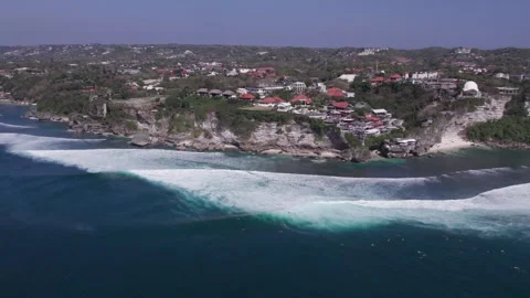 Aerial 4K view of a cliff, ocean waves, beach at Uluwatu, Bali, Indonesia Stock Footage 325085752