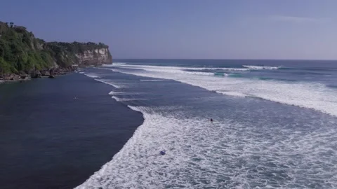 Aerial 4K view of a cliff, ocean waves, beach at Uluwatu, Bali, Indonesia Stock Footage 325086080