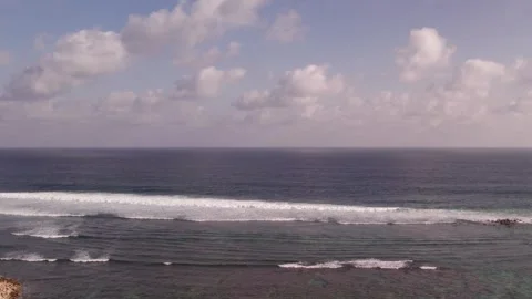 Aerial 4K view of a cliff, ocean waves, beach at Uluwatu, Bali, Indonesia Stock Footage 325086253