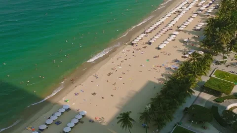 Aerial 4K view of crowded Nha Trang beach with tourists sunbathing Vietnam Stock Footage 333578786
