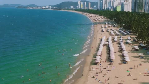 Aerial 4K view of crowded Nha Trang beach with tourists sunbathing Vietnam Stock Footage 333578796