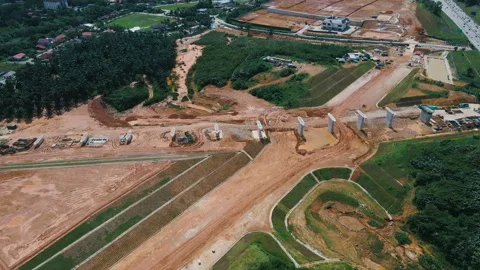 Aerial 4K view of the ECRL construction site with pillars, red earth, and n.. Stock Footage 301552167