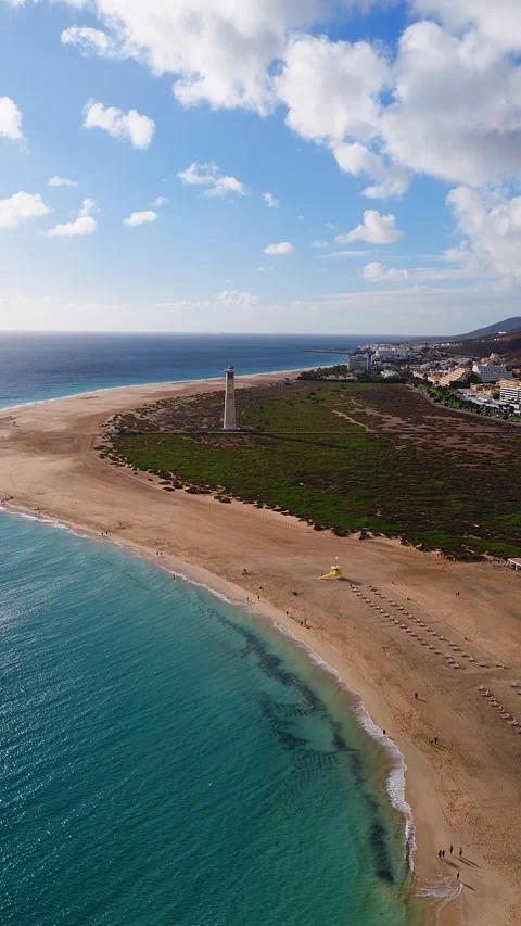 Aerial 4K view of Morro Jable lighthouse and sandy spit, Fuerteventura Stock Footage 326208640