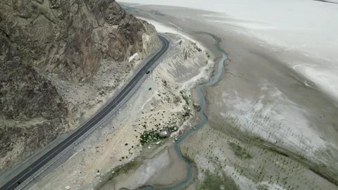 Aerial 4K View of Skardu Road with Indus River and Riverside Trees Stock Footage 306594341