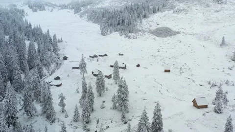 Aerial 4k view of snow capped abandoned cabins in mountains Stock Footage 141454782