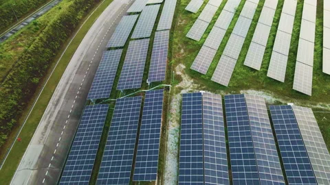 Aerial 4K view of solar panel installations on a landscaped field. Stock Footage 300203900