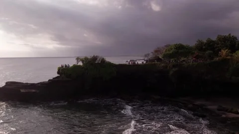 Aerial 4K view Of Sunset Beach Tanah Lot in Bali, Indonesia Stock Footage 325051679