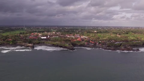 Aerial 4K view Of Sunset Beach Tanah Lot in Bali, Indonesia Stock Footage 325052155