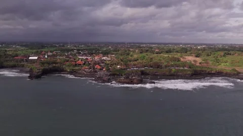 Aerial 4K view Of Sunset Beach Tanah Lot in Bali, Indonesia Stock Footage 325052156