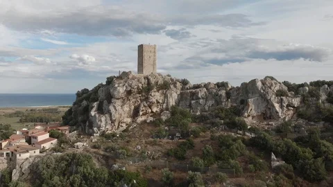 Aerial 4k view of tower castle and medieval town with valley and sea - Posada Vídeo Stock 125873019