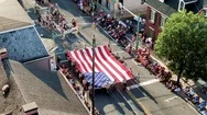 Aerial Of 4Th Of July Parade, Boy Scouts Carry Large American Flag, Cub Stock Footage