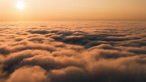 Aerial above the clouds at sunset timelapse Stock Footage 258269076