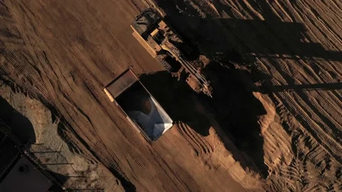 Aerial above excavator loading a dump truck with dirt on a construction site Stock Footage 130667683
