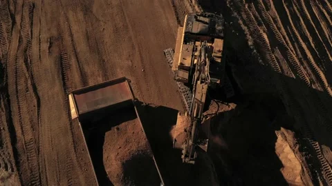 Aerial above excavator loading a dump truck with dirt on a construction site Stock Footage 146923560