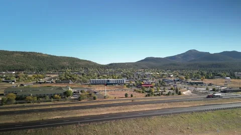 Aerial above Interstate 40 through Williams Arizona on autumn day Stock Footage 253413962