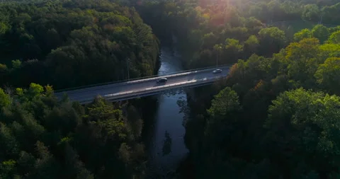 Aerial Above River Valley Passing Over High Bridge And Vehicle At Sunset Dusk Stock-Footage 200048687