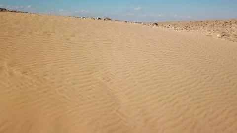 Aerial above sand dune pattern at the desert. Fly over desert landscape with Stock Footage 145532746