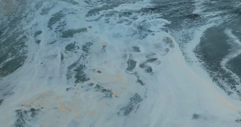 Aerial: Abstract texture of ocean wave foam at sunset. Bethells Beach, Auckland, Stock Footage 263687723