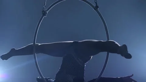 Aerial acrobat in the ring. A young girl performs the acrobatic elements in the Stock Footage 110683027