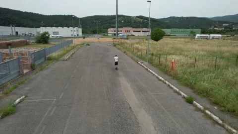 Aerial active track view of man on electric scooter driving alone  스톡 동영상 165500167