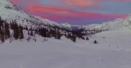 Aerial Of Adventurers Waving On Their Snowmobiles On A Snowy Land At Sunset Stock Footage