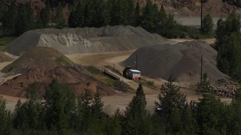 Aerial of aggregate rock processing facility and gravel piles in Cataldo Idaho Stock Footage 337389721
