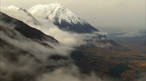 Aerial Alaskan Mountain Range cloud snow forest climbing USA Stock Footage