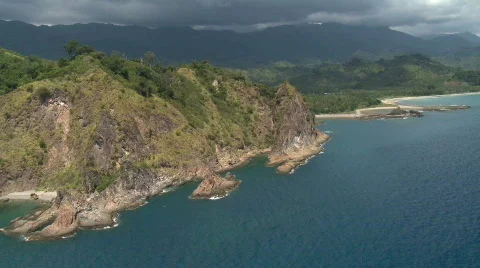 Aerial along cliff while dangerously looking clouds are formed at the mountains  Stock Footage 644723