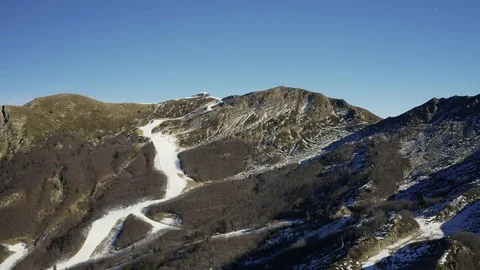 Aerial, Alps mountains partially covered with snow in Italy Video stock 108977076