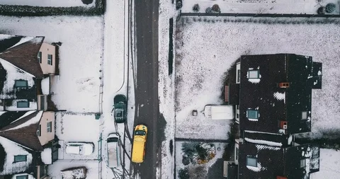 Aerial: ambulance car is driving through residental area on snowy day Stock Footage