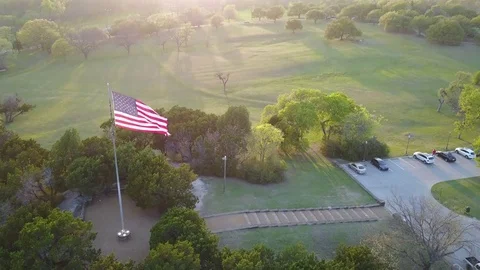 Aerial American Flag Orbit In Park Landscape Stock Footage