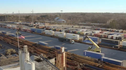 Aerial - American Flag waves at intermodal rail terminal Stock Footage 146126254