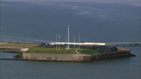 Aerial of American flag waving with wind, tourists enjoying on the coast, Fort Stock Footage 109141663