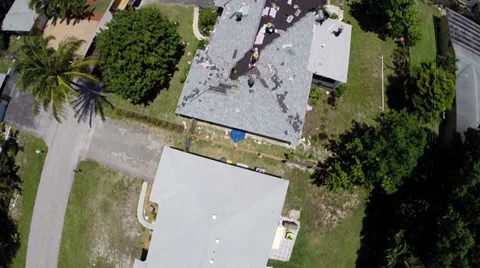 Aerial Angle of workers building a new roof in a residential neighborhood. Stock Footage 38643721