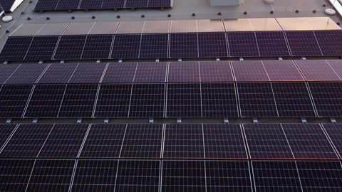 Aerial angled pullback of solar panel array, organized photovoltaic cells on Stock Footage 305056612