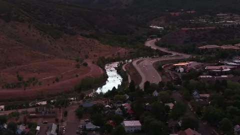 Aerial of Animas River flowing through small town in Durango Colorado at sunset Stock Footage 342479150