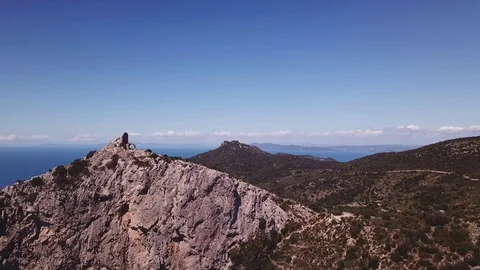 Aerial approach to a peak with Tower on a cliff by the sea, sunny summer day Stock Footage 107189495