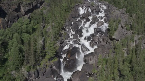 Aerial approach to a rocky waterfall View of the valley with a powerful river Stock Footage 123710951