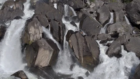 Aerial approach to a rocky waterfall View of the valley with a powerful river Stock Footage 123714068