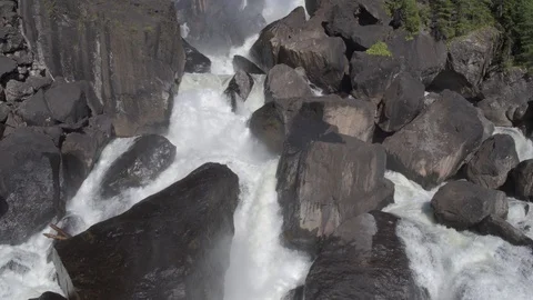 Aerial approach to a rocky waterfall View of the valley with a powerful river Stock Footage 123714167